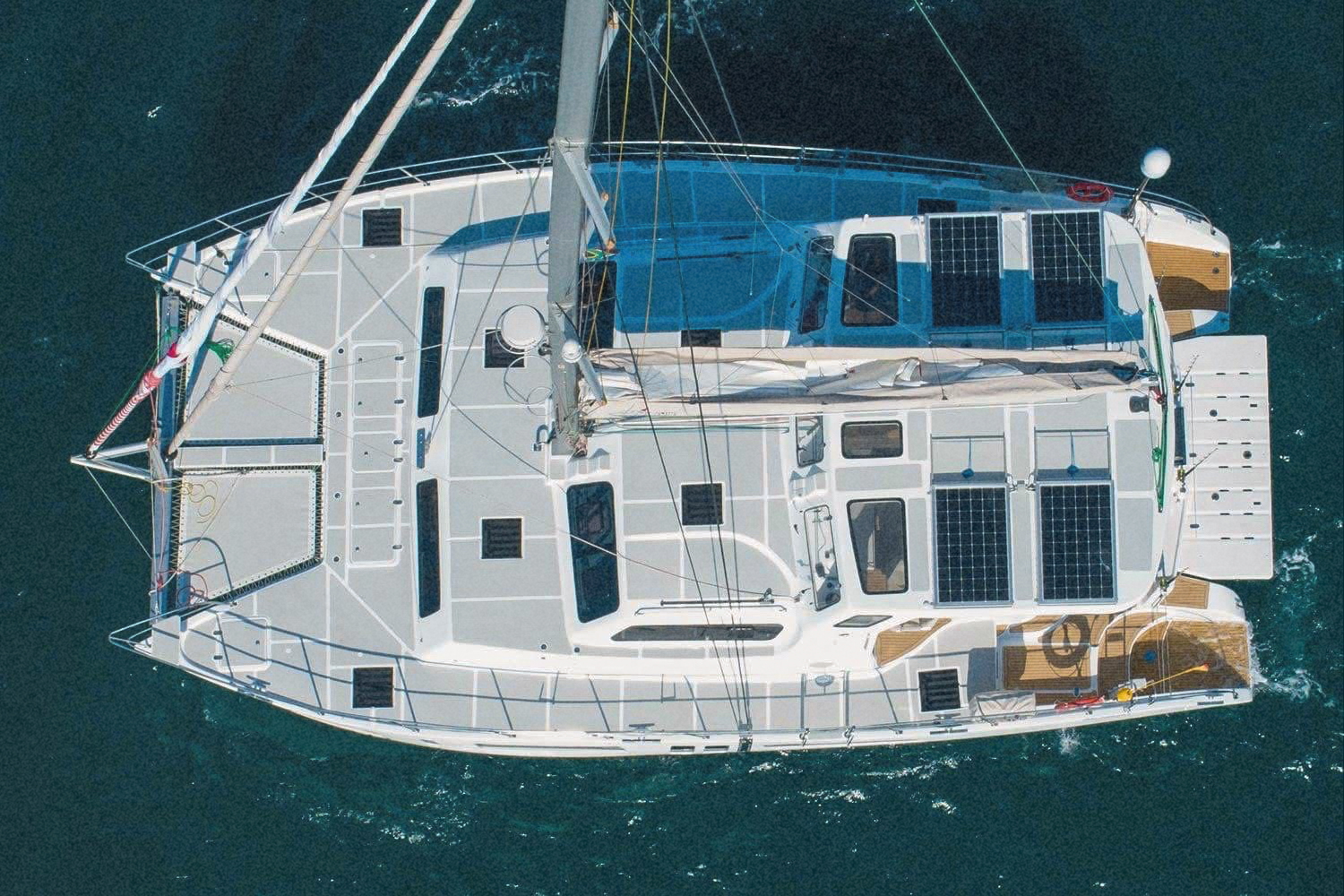 Aerial view from directly above the catamaran, showing the full deck and solar panels
